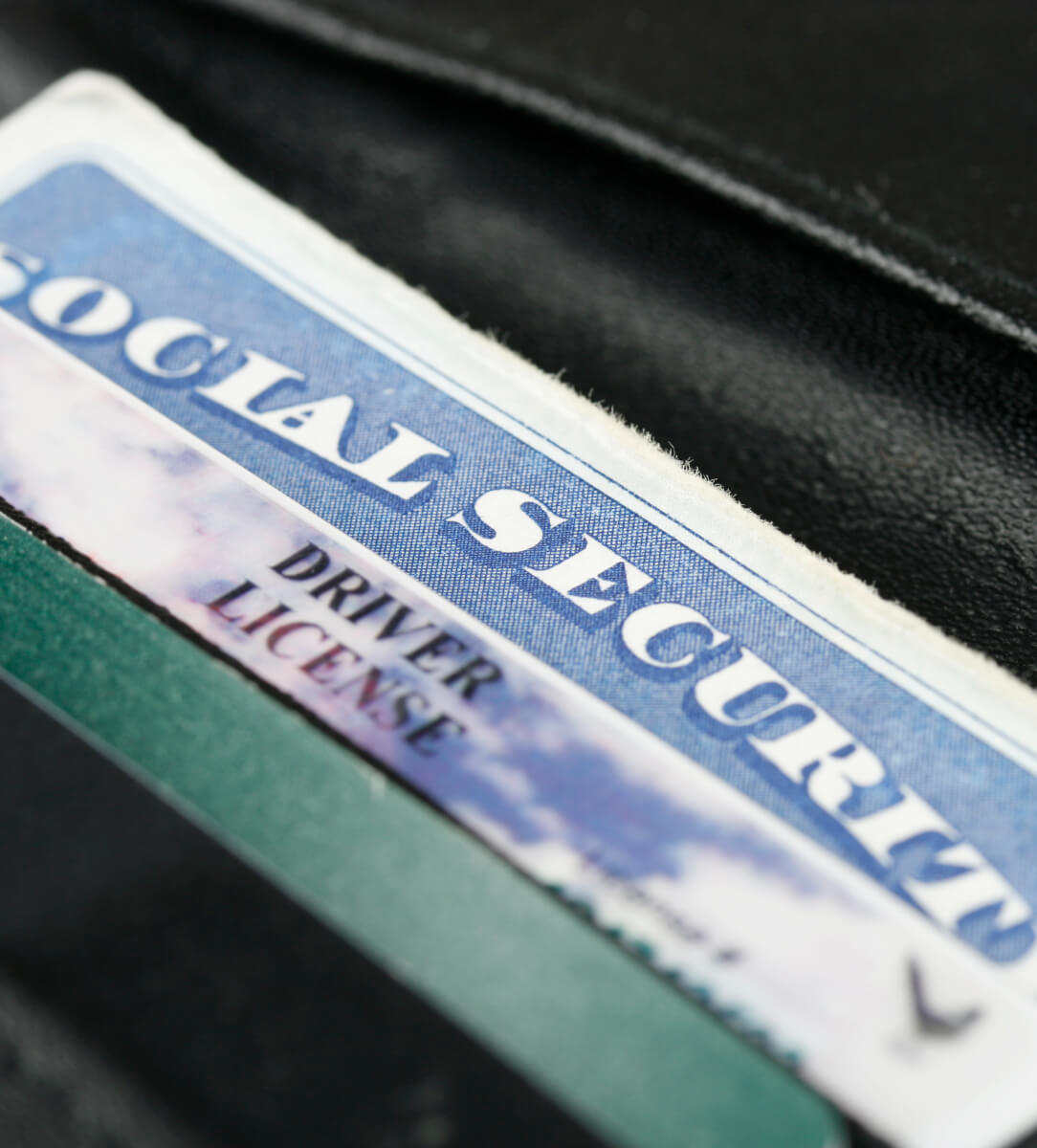 Close-up of a social security card and driver's license in wallet.