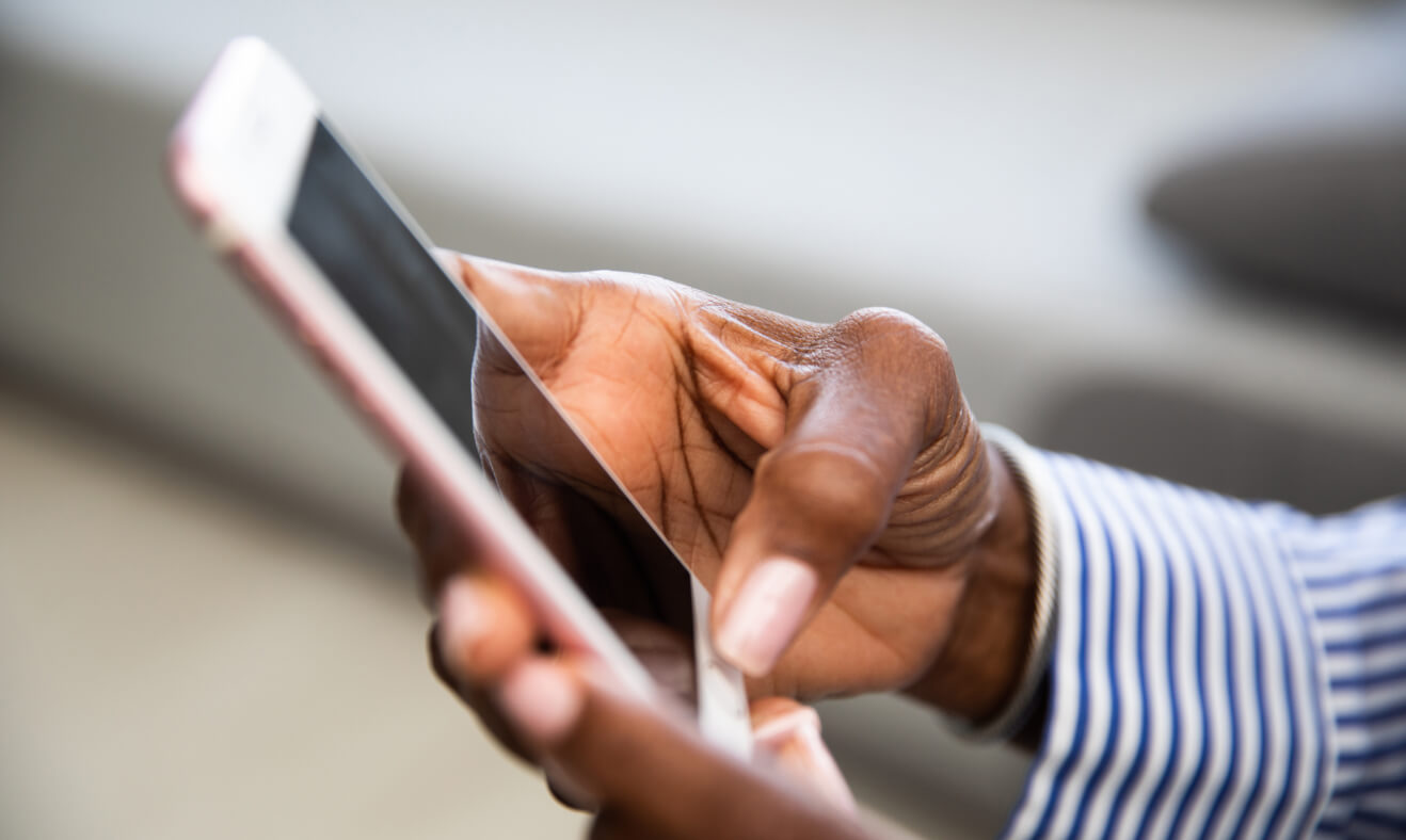 Close-up of hands using a smartphone.