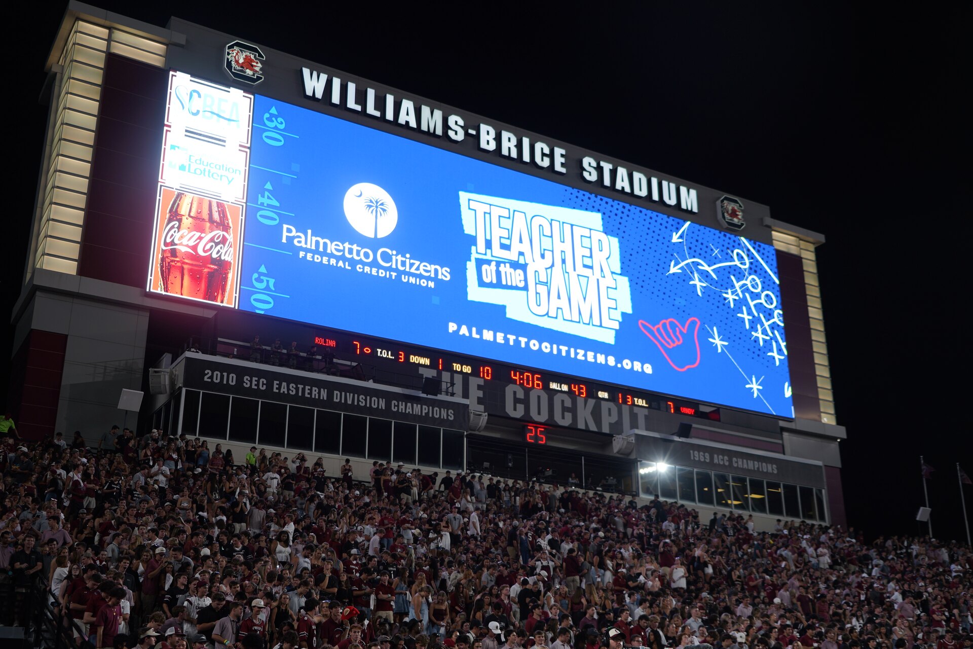 Williams-Brice Stadium scoreboard displaying a Palmetto Citizens Teacher of the Game graphic.